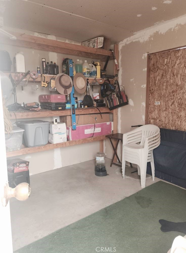 5348 Gatson Street Bakersfield, CA 93314 - Photo 23 of 33 a room with wooden cabinets and table