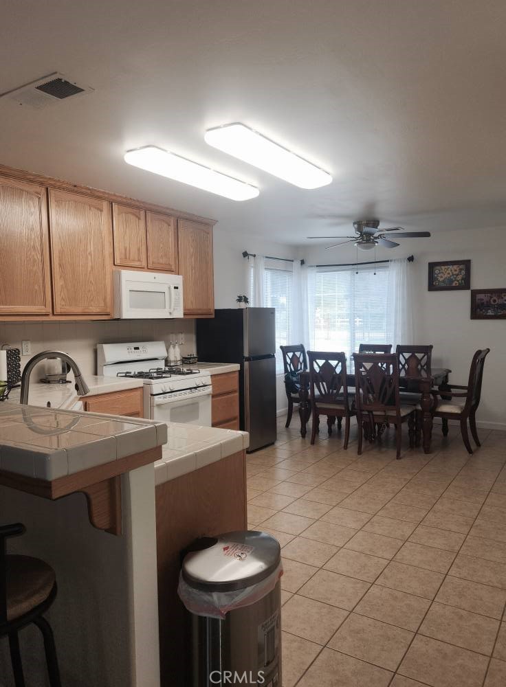 5348 Gatson Street Bakersfield, CA 93314 - Photo 9 of 33 a kitchen with lots of counter space and appliances