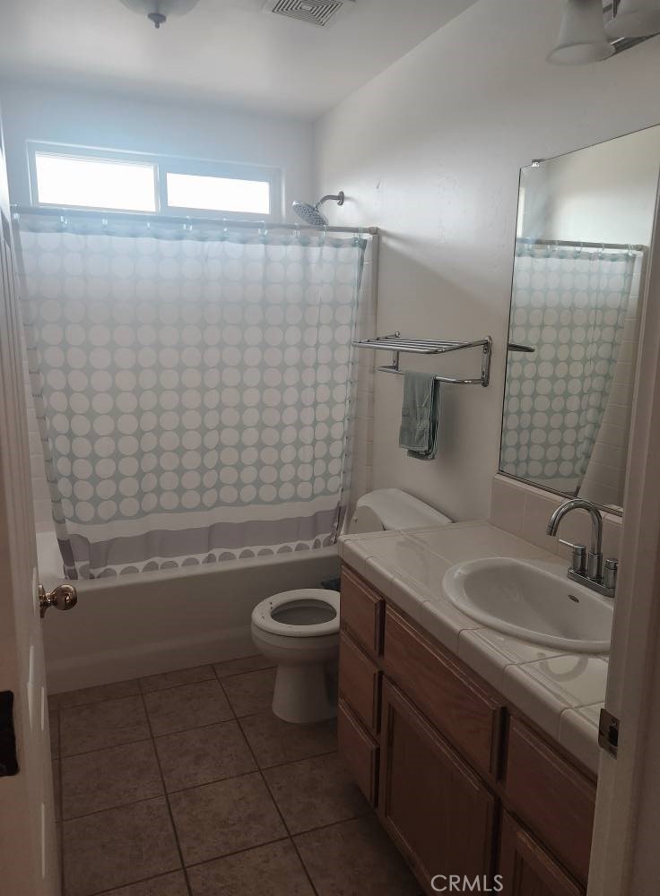 5348 Gatson Street Bakersfield, CA 93314 - Photo 10 of 33 a bathroom with a sink a toilet and shower