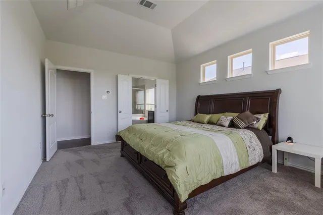 a bedroom with a bed and window