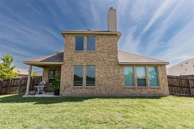 a view of house with yard and entertaining space