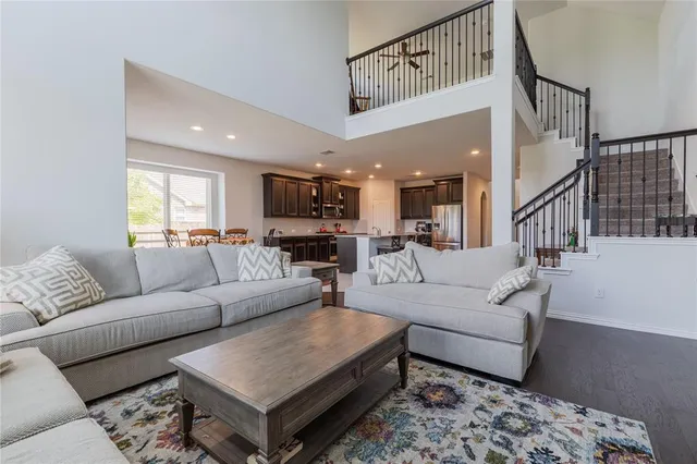 a living room with furniture and a view of kitchen