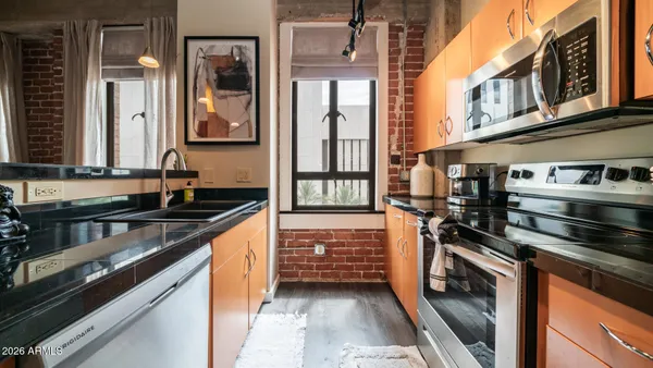 a kitchen with stainless steel appliances a stove and a sink