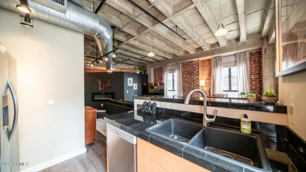 a kitchen with stainless steel appliances granite countertop a sink and a counter space