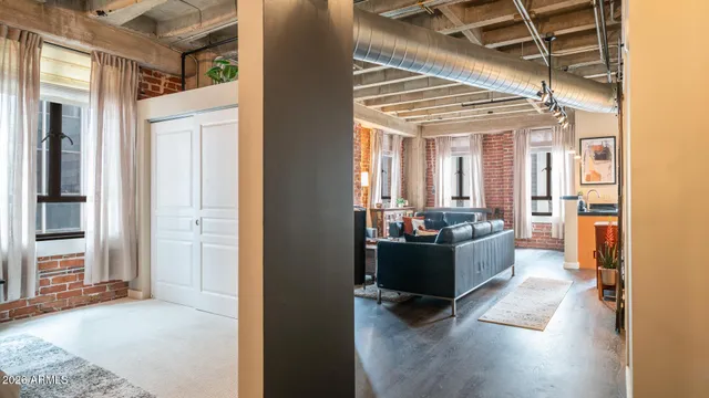 a view of a bedroom with a bed and glass door