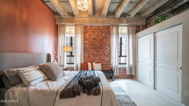 a bedroom with a bed and a mirror