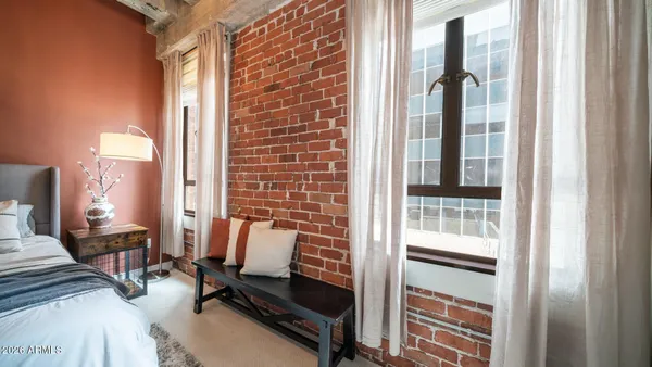 a view of a bedroom with a bed and glass door