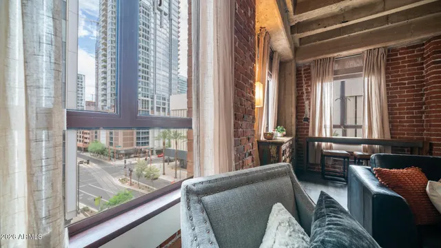 a living room with furniture and large windows