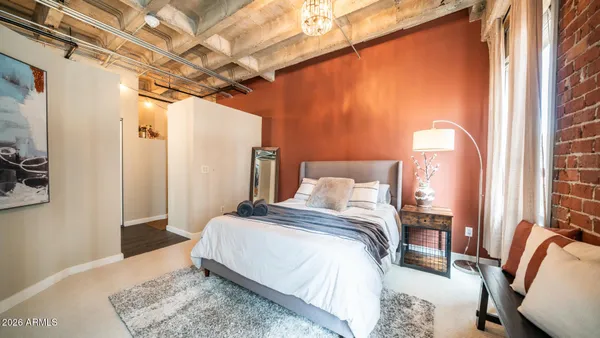 a bedroom with a bed and a mirror