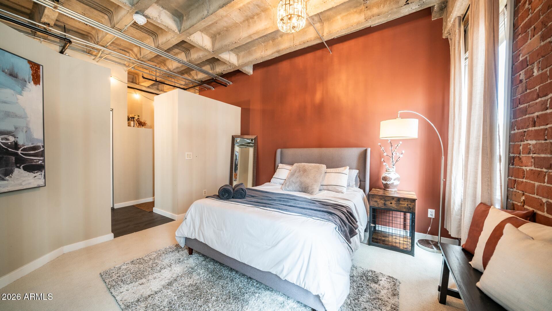 114 West Adams Street, Unit 503 Phoenix, AZ 85003 - Photo 21 of 46 a bedroom with a bed and a mirror