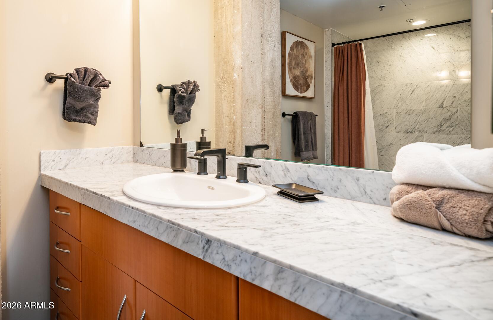 114 West Adams Street, Unit 503 Phoenix, AZ 85003 - Photo 25 of 46 a bathroom with a granite countertop sink and a mirror