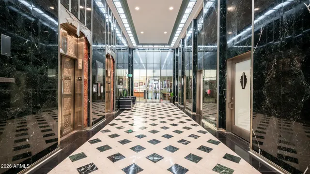 a living room with patio chairs and a dining table with wooden floor