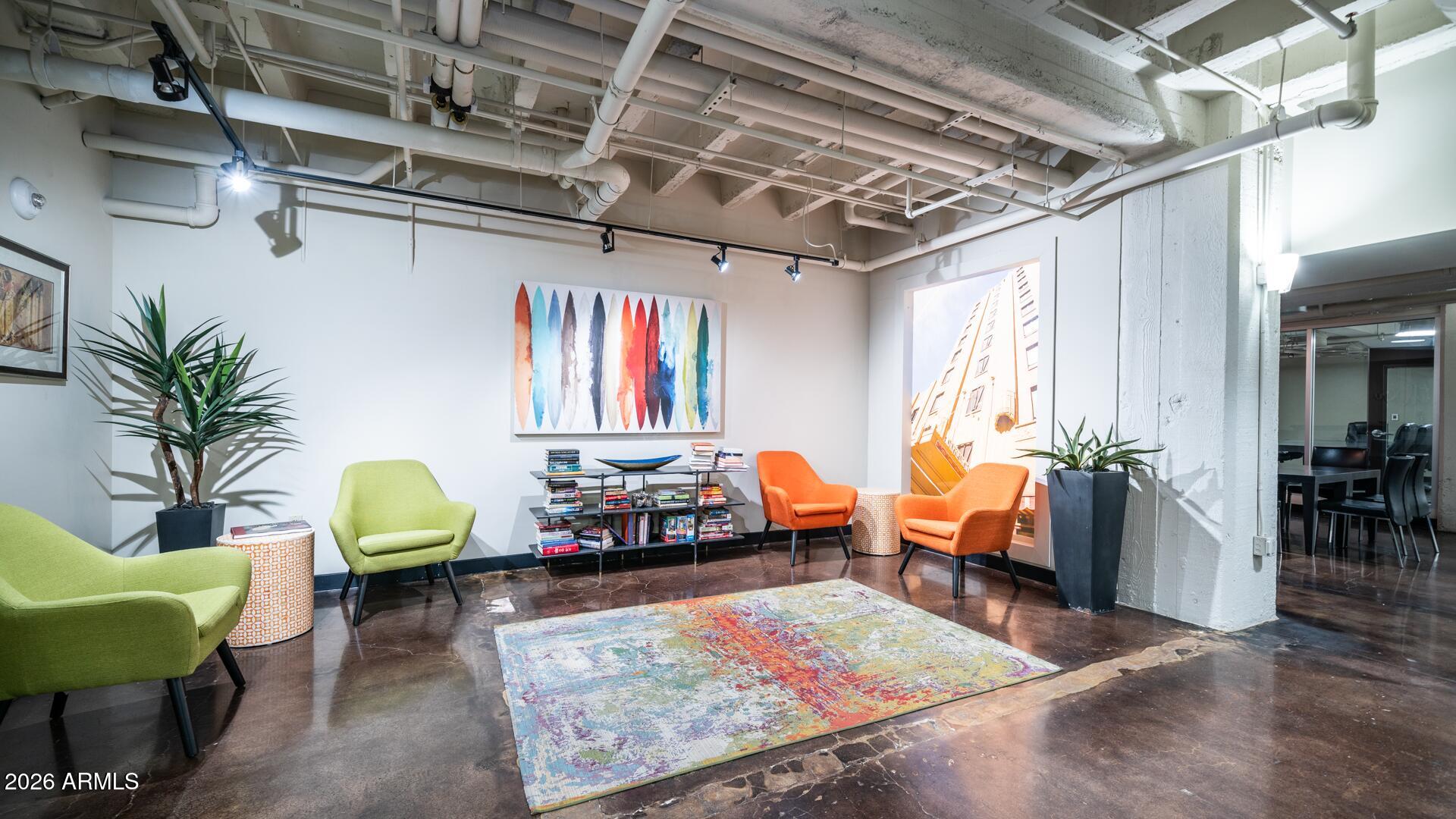 114 West Adams Street, Unit 503 Phoenix, AZ 85003 - Photo 34 of 46 a living room with patio chairs and a dining table with wooden floor