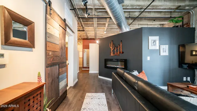 a view of a hallway with workspace and a window