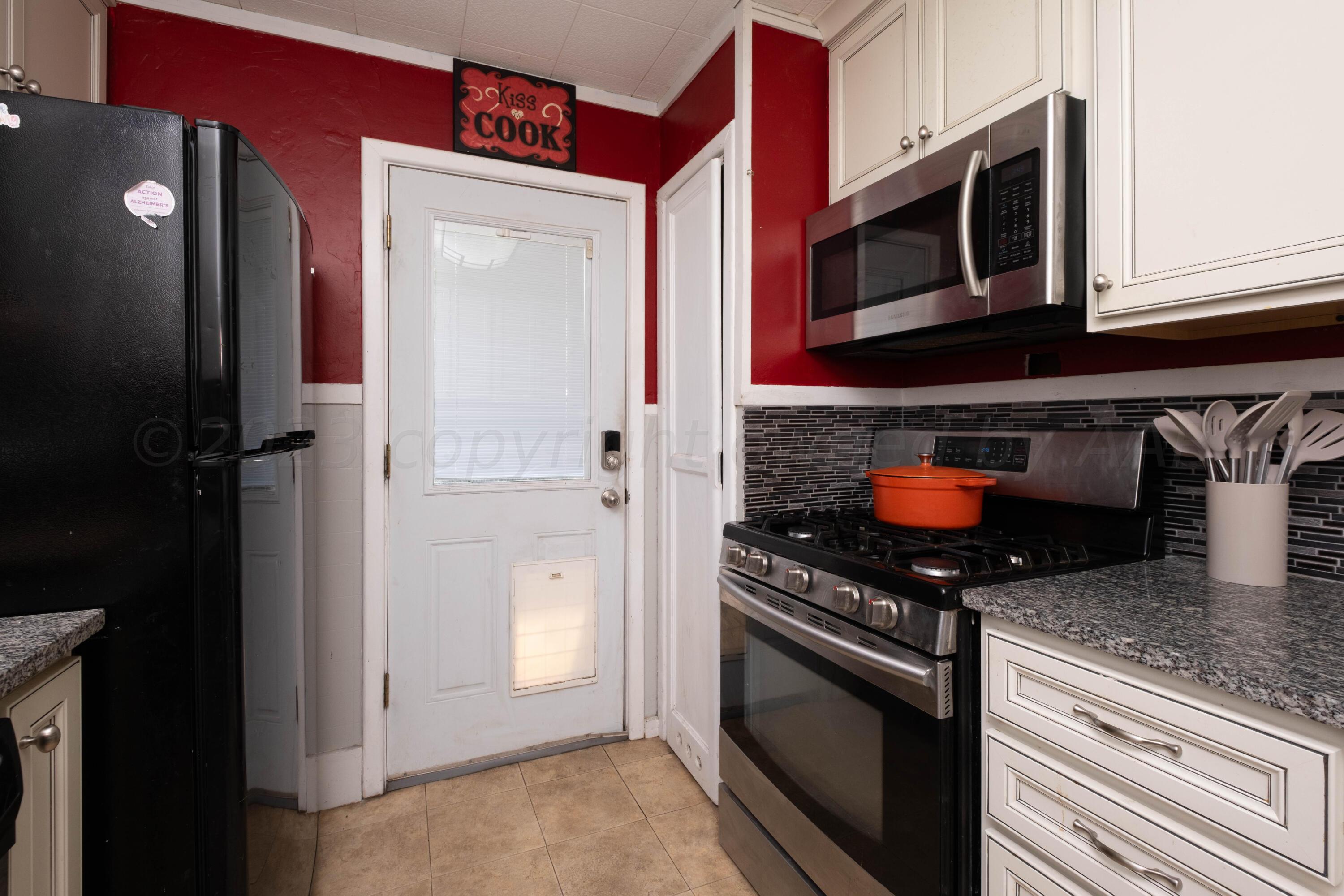 3607 South Lipscomb Street Amarillo, TX 79110 - Photo 11 of 20 a kitchen with stainless steel appliances granite countertop a refrigerator and a stove top oven