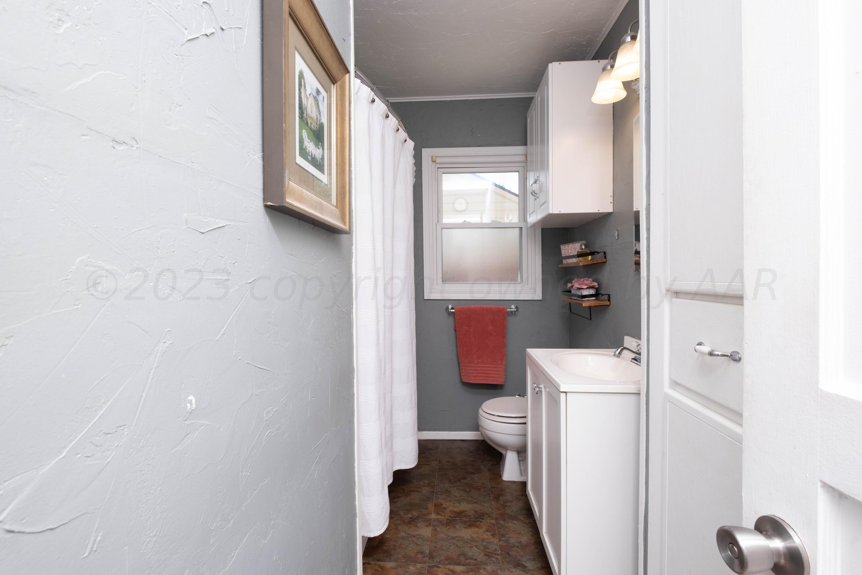 3607 South Lipscomb Street Amarillo, TX 79110 - Photo 14 of 20 a bathroom with a toilet and a shower