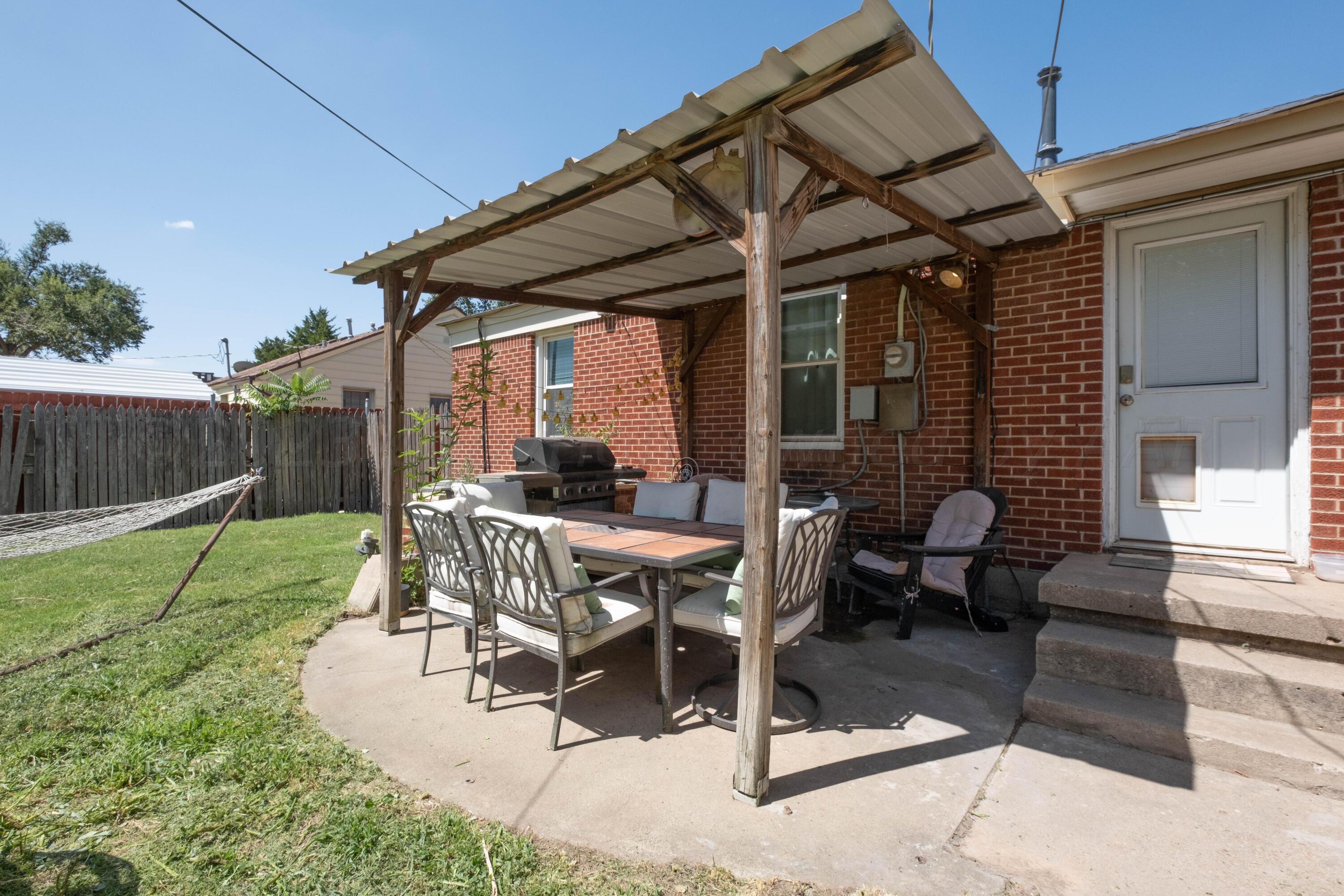 3607 South Lipscomb Street Amarillo, TX 79110 - Photo 17 of 20 a view of a patio with table and chairs with wooden fence