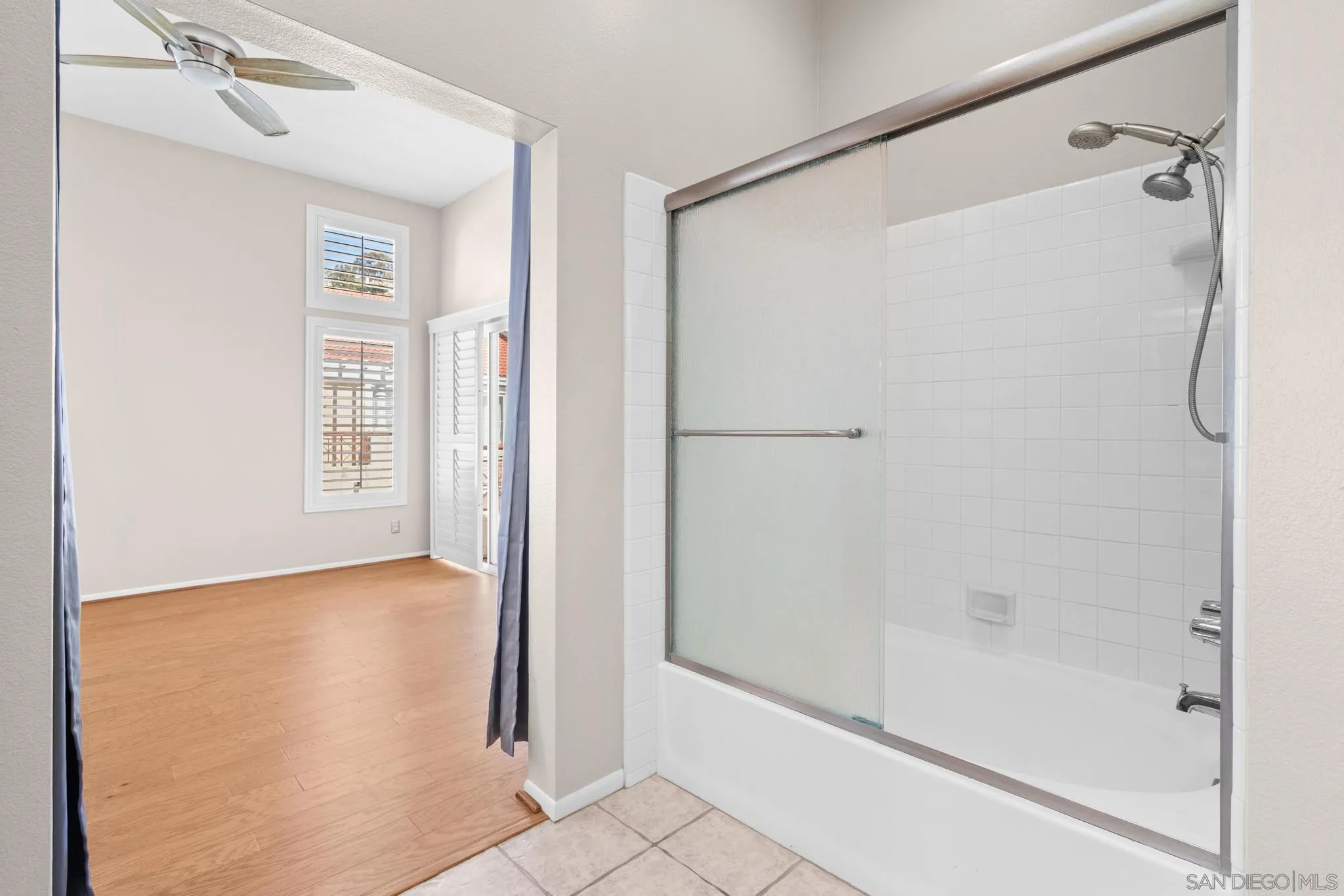 9338 Babauta Road, Unit 78 San Diego, CA 92129 - Photo 17 of 26 a bathroom with a glass shower door