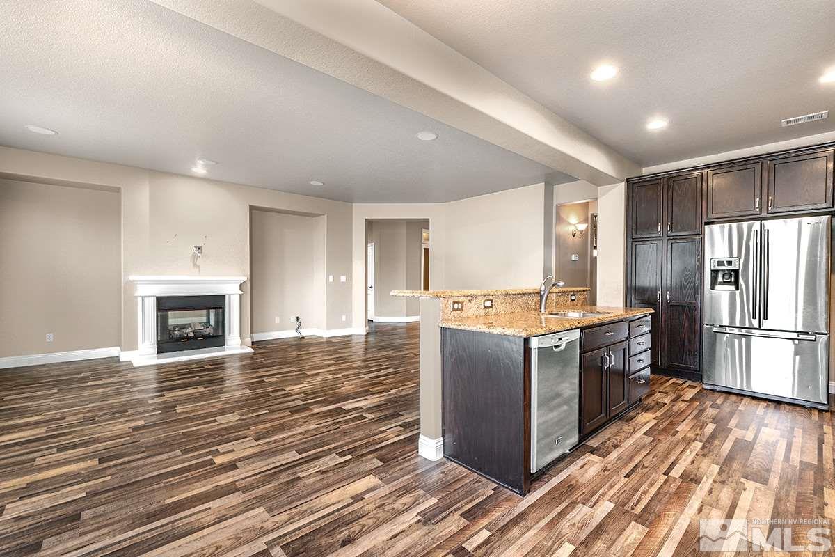 a view of kitchen with sink microwave and refrigerator