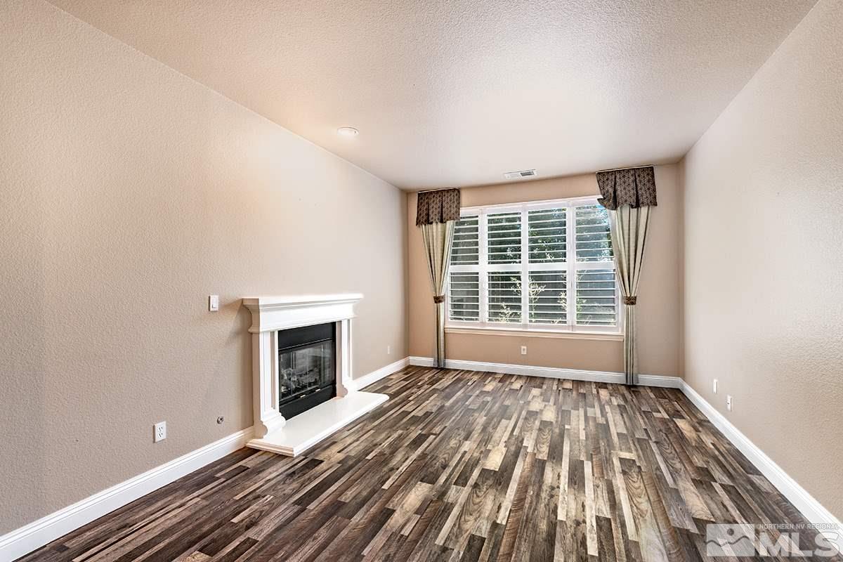 14085 Winners Cup Drive Reno, NV 89521 - Photo 8 of 20 a view of an empty room with a window and fireplace