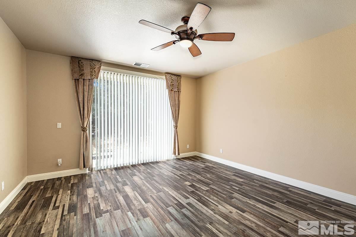 14085 Winners Cup Drive Reno, NV 89521 - Photo 9 of 20 wooden floor in an empty room with a window