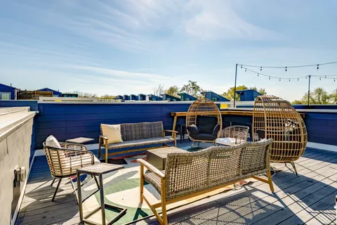 a view of a roof deck with furniture