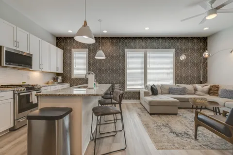 a kitchen that has a sink and a stove