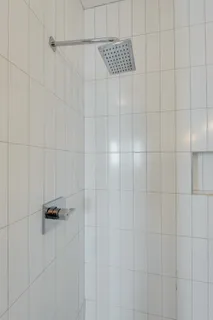 a living room with furniture a flat screen tv and a chandelier