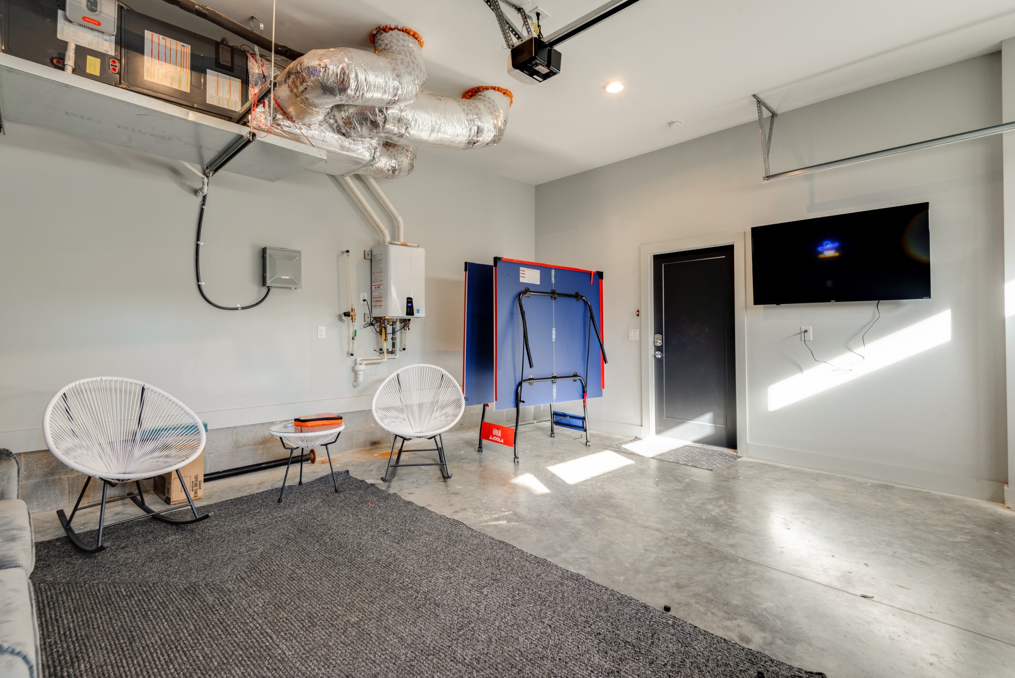 1112 Harmony Way Nashville, TN 37207 - Photo 36 of 44 a living room with furniture a flat screen tv and a chandelier