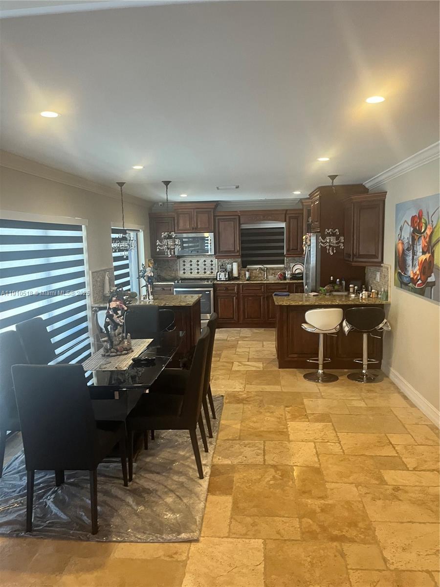 20305 Northeast 10th Court Miami, FL 33179 - Photo 4 of 10 a living room with kitchen furniture and a kitchen view