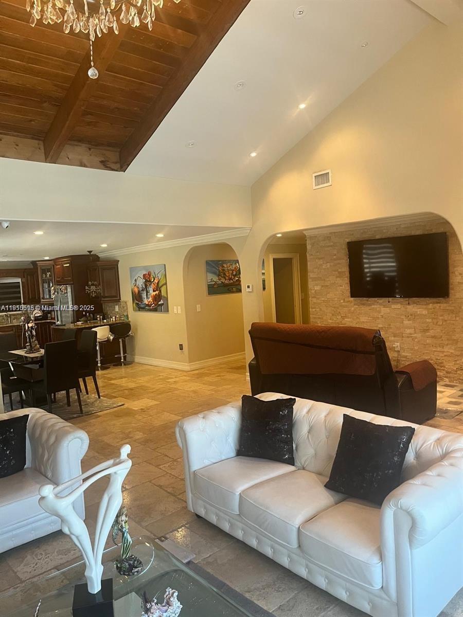 20305 Northeast 10th Court Miami, FL 33179 - Photo 8 of 10 a living room with furniture and a flat screen tv