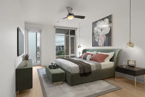 a bedroom with a bed and a chandelier