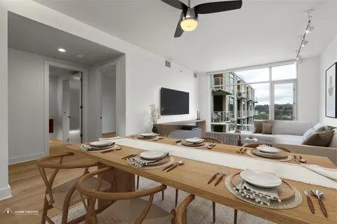 a dining room with furniture and a flat screen tv