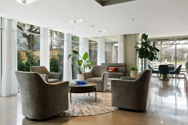a living room with furniture and a potted plant