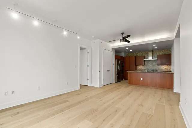 a large white kitchen with a sink and cabinets
