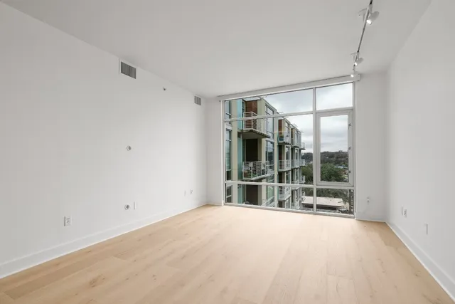 a view of empty room with floor to ceiling window