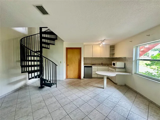 a kitchen with a sink cabinets and appliances