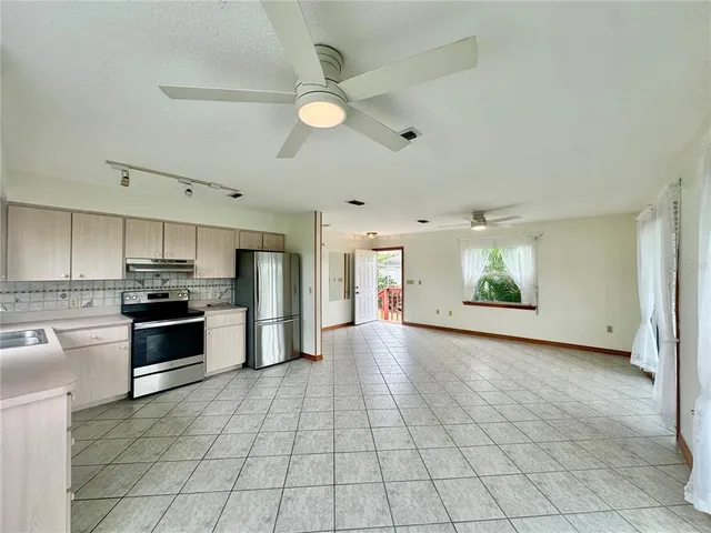 a large kitchen with cabinets and stainless steel appliances