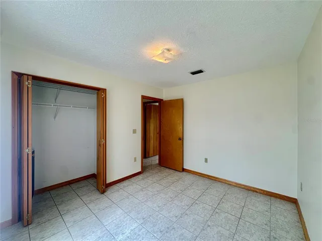 an empty room with closet area