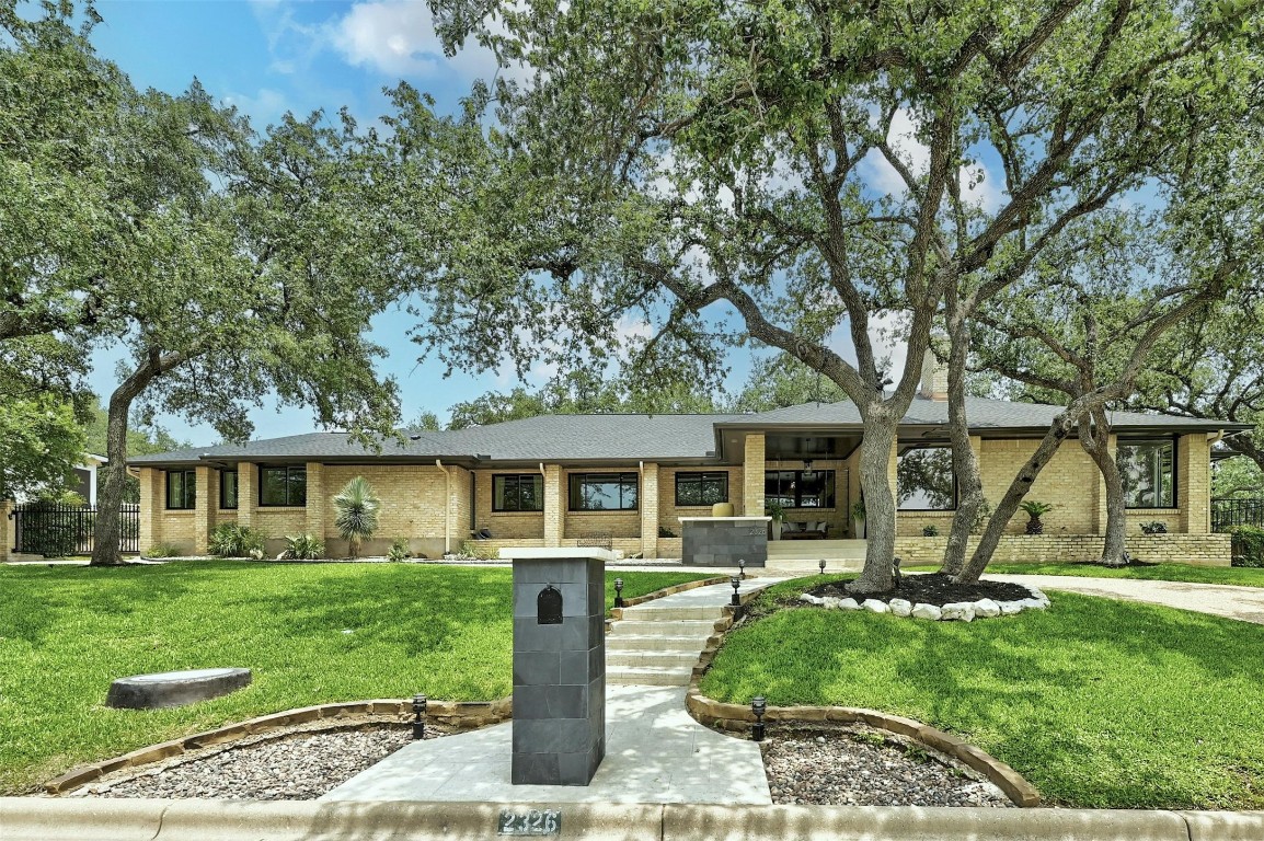 a front view of house with yard and green space