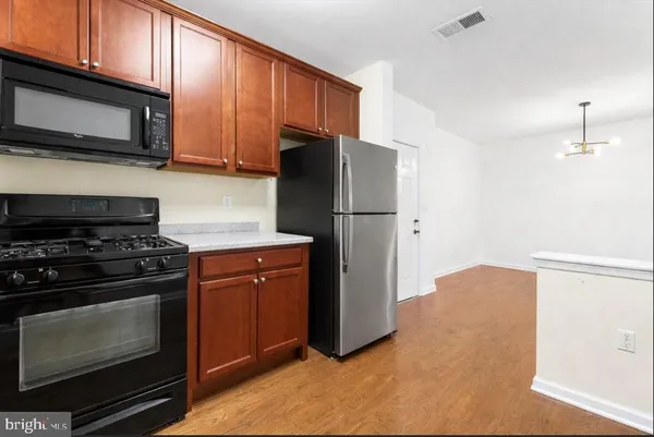a living room with fireplace furniture and a wooden floor