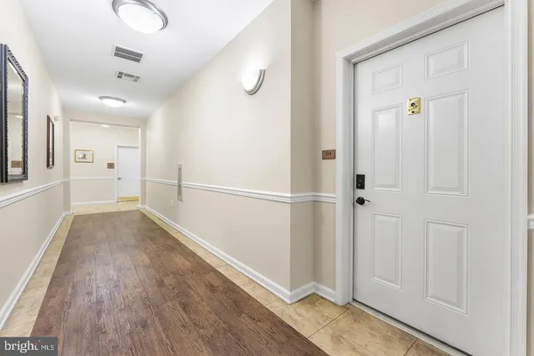 a view of a hallway with wooden floor