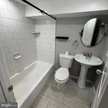 a bathroom with a sink toilet and bathtub