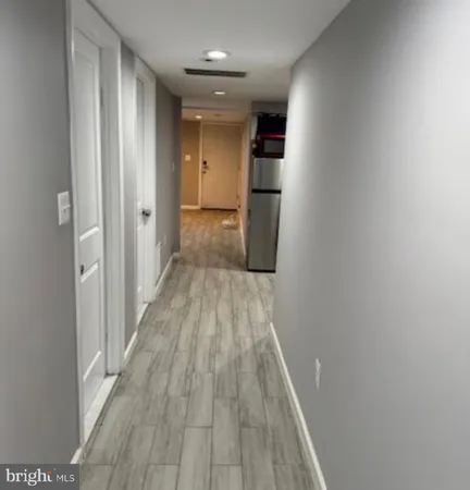 a view of a hallway with wooden floor