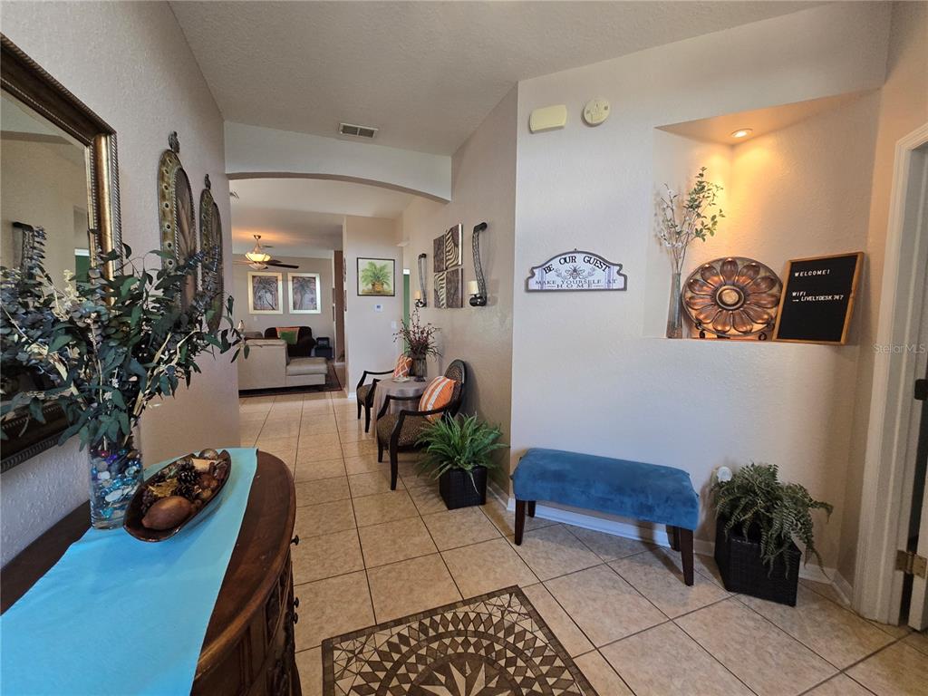 219 Cloverdale Road Winter Haven, FL 33884 - Photo 5 of 29 a living room with furniture and a potted plant