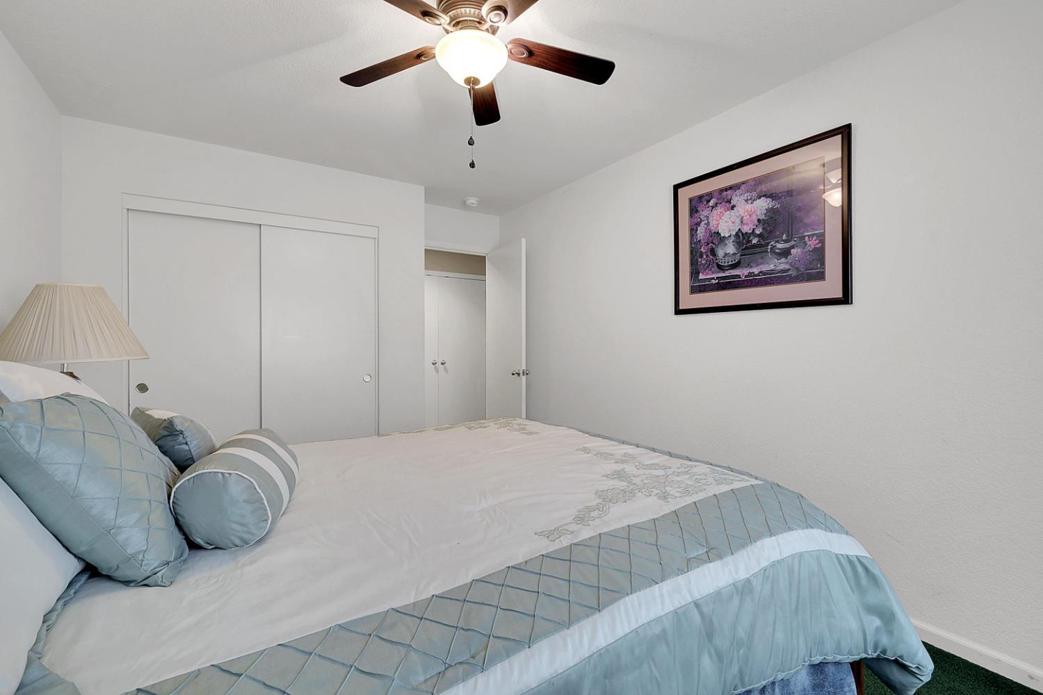 9840 Ellis Way Live Oak, CA 95953 - Photo 35 of 44 a bedroom with a bed and a chandelier