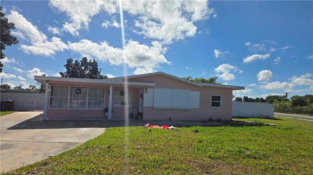 10 East Jersey Road Lehigh Acres, FL 33936 - Photo 1 of 7 View of front of house with a sunroom and stucco siding