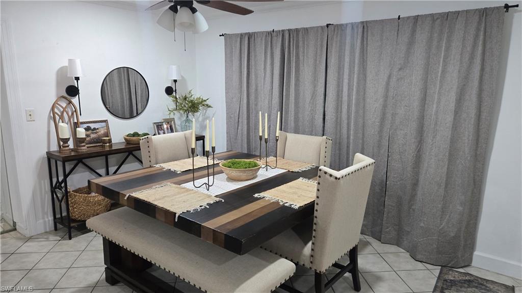 10 East Jersey Road Lehigh Acres, FL 33936 - Photo 4 of 7 Dining space featuring light tile patterned flooring, ceiling fan, and ornamental molding