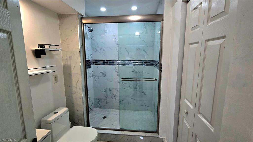 10 East Jersey Road Lehigh Acres, FL 33936 - Photo 6 of 7 Full bathroom with a stall shower, recessed lighting, and vanity