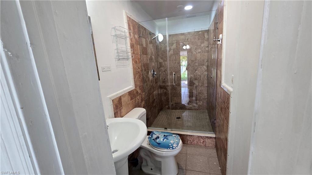 10 East Jersey Road Lehigh Acres, FL 33936 - Photo 7 of 7 Bathroom with a stall shower and tile patterned floors